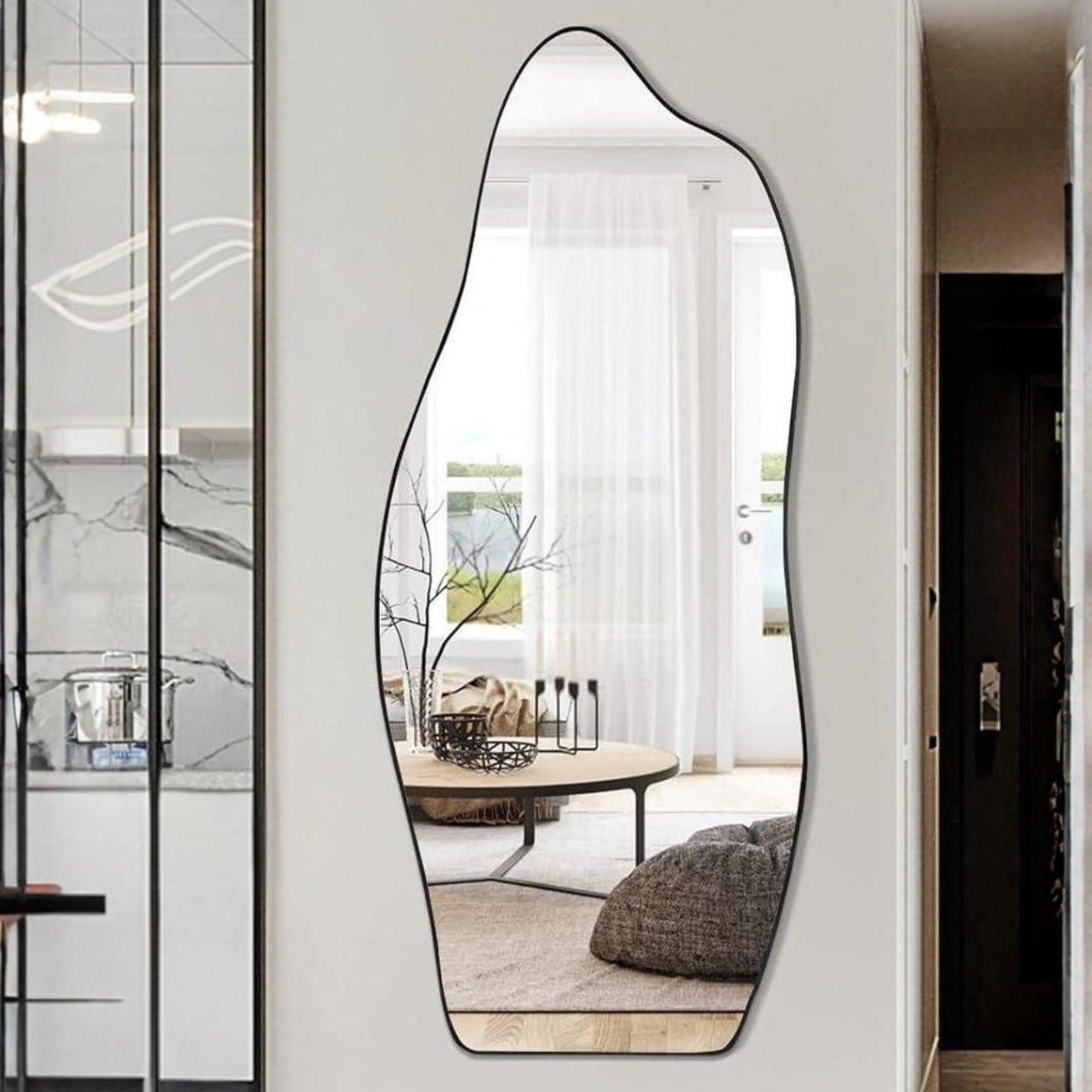 Modern wall mirror with a unique, wavy design in a home interior setting.